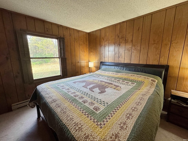 bedroom featuring a textured ceiling, wooden walls, a baseboard radiator, and carpet flooring