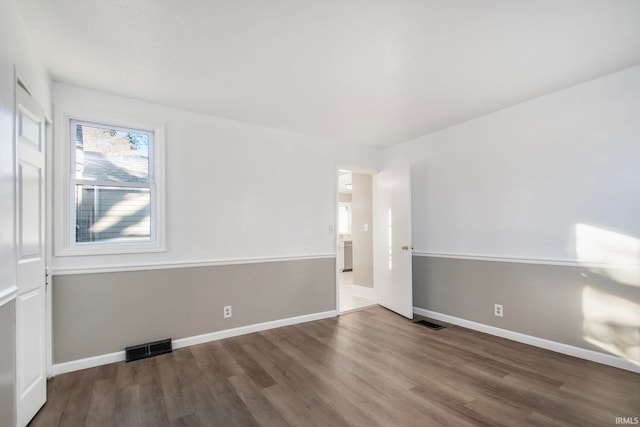 spare room featuring hardwood / wood-style flooring