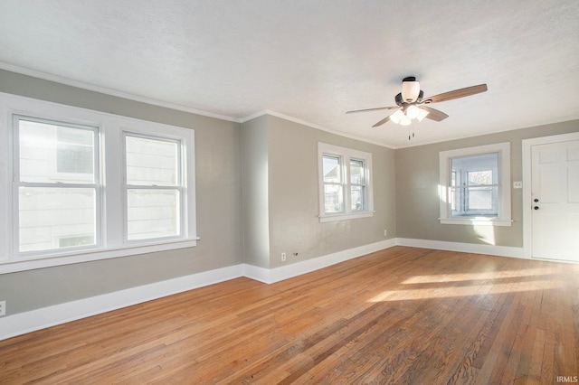 spare room featuring ornamental molding, a textured ceiling, hardwood / wood-style flooring, and ceiling fan