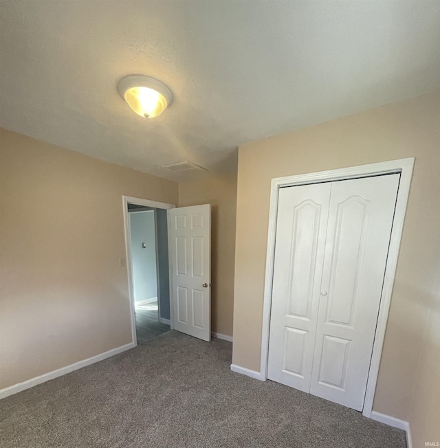 unfurnished bedroom with carpet and a closet