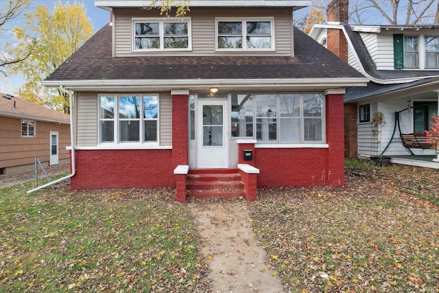 view of front of property featuring a sunroom