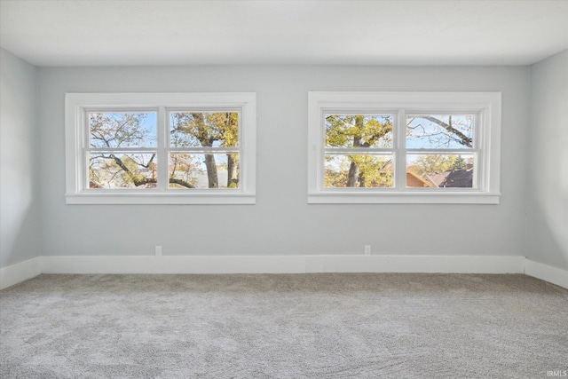 carpeted empty room with a wealth of natural light