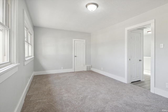 unfurnished room with light colored carpet