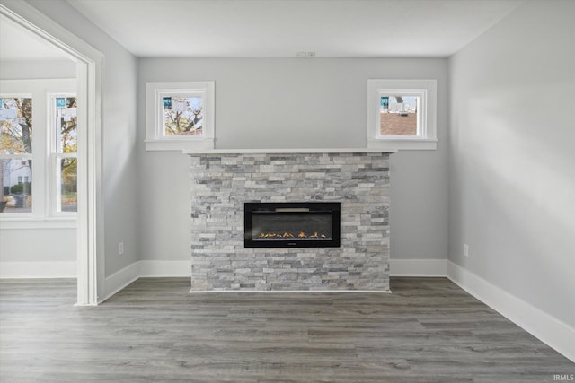 unfurnished living room with dark hardwood / wood-style flooring and a fireplace