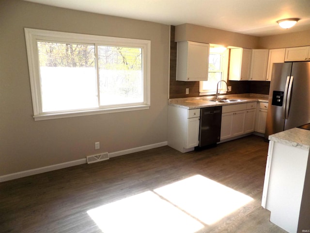 kitchen featuring dishwasher, a wealth of natural light, white cabinets, and stainless steel fridge with ice dispenser