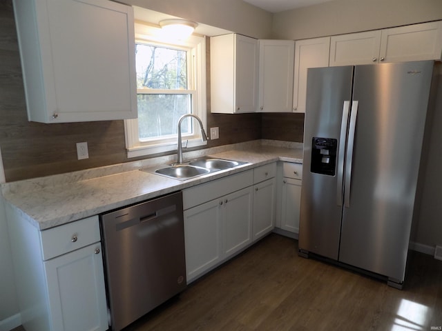 kitchen with white cabinets, sink, tasteful backsplash, dark hardwood / wood-style floors, and appliances with stainless steel finishes