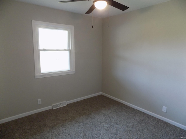 carpeted spare room featuring ceiling fan