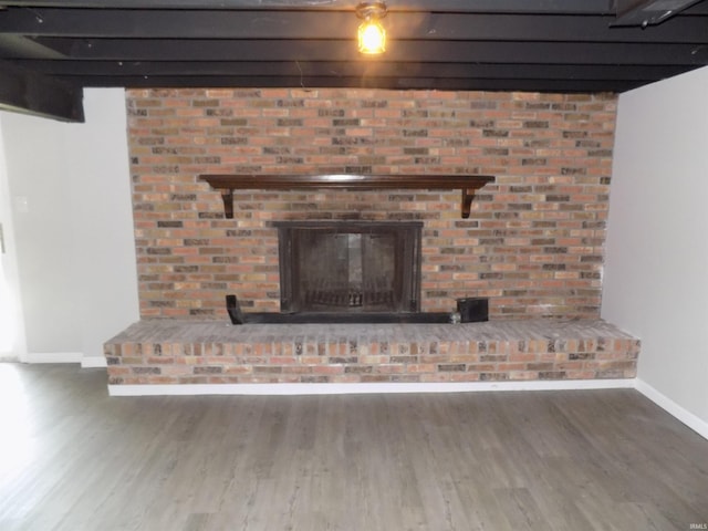 interior details with hardwood / wood-style flooring and a brick fireplace