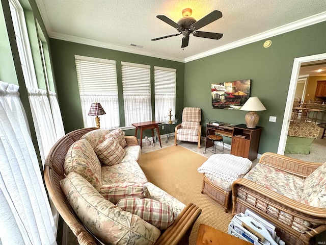 living room with ceiling fan, a textured ceiling, carpet flooring, and ornamental molding