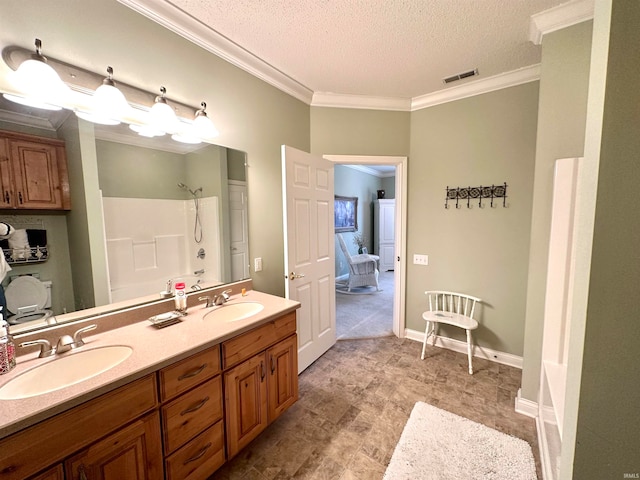 bathroom with toilet, vanity, a textured ceiling, and crown molding