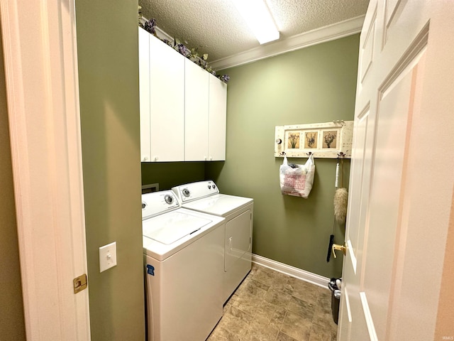 laundry room featuring cabinets, a textured ceiling, separate washer and dryer, and crown molding