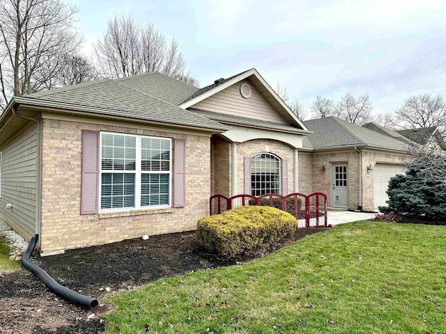 ranch-style home with a garage and a front yard