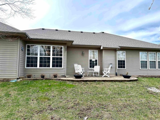 back of property featuring a yard and a wooden deck