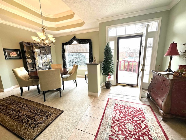 tiled foyer featuring a notable chandelier, crown molding, and a tray ceiling