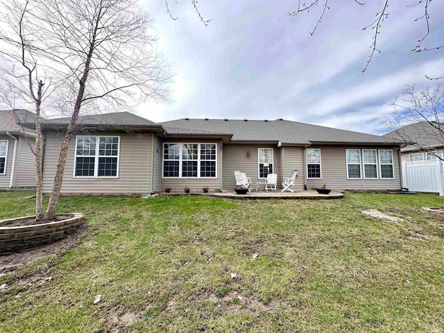 rear view of property featuring a yard and a patio area