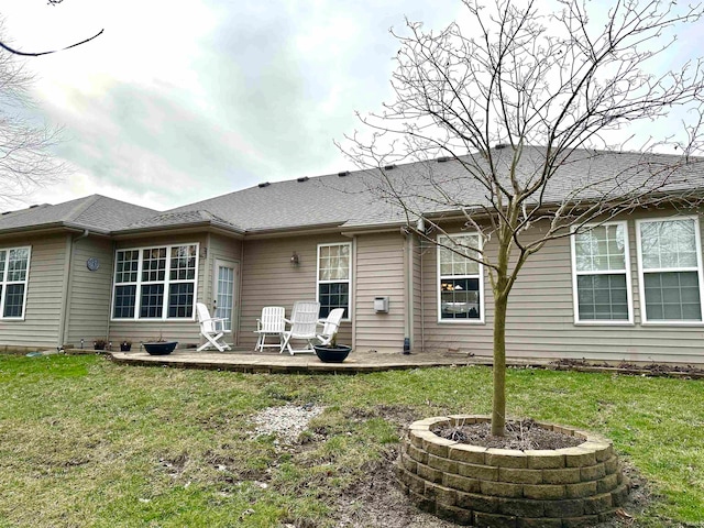 rear view of property with a lawn and a patio area