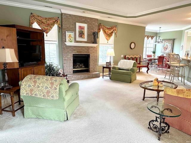 carpeted living room featuring a brick fireplace, a healthy amount of sunlight, an inviting chandelier, and crown molding