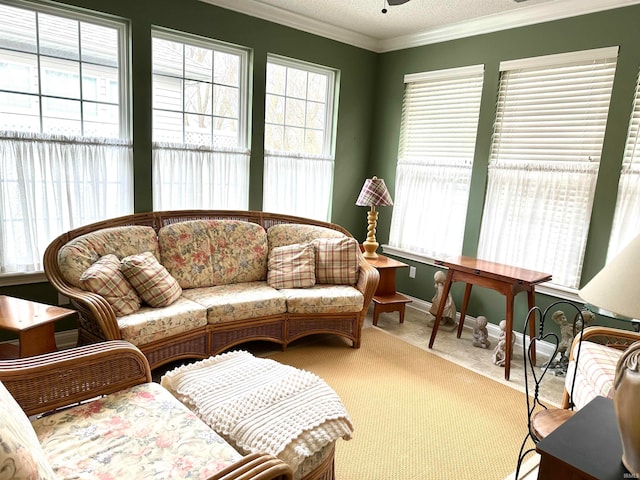 carpeted living room featuring ornamental molding, a textured ceiling, and ceiling fan