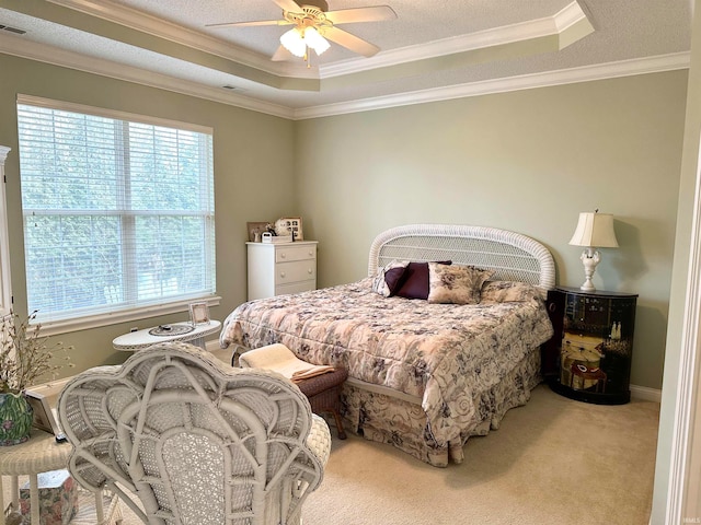 bedroom featuring ornamental molding, carpet, ceiling fan, and a raised ceiling