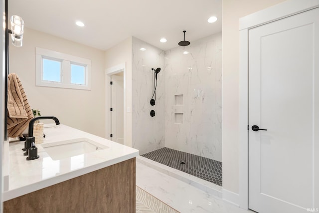 bathroom with vanity and a tile shower