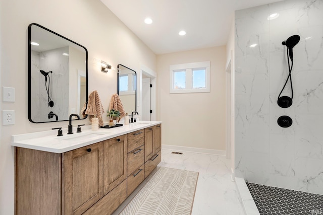 bathroom with tiled shower and vanity