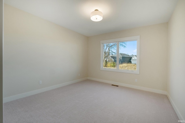 unfurnished room with light carpet