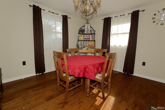 dining area featuring hardwood / wood-style floors and a notable chandelier