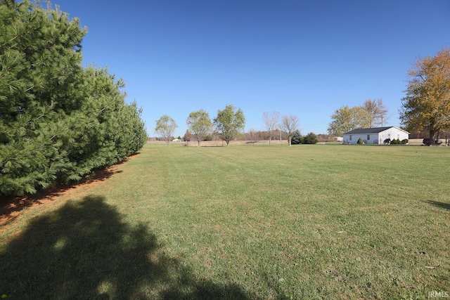 view of yard with a rural view