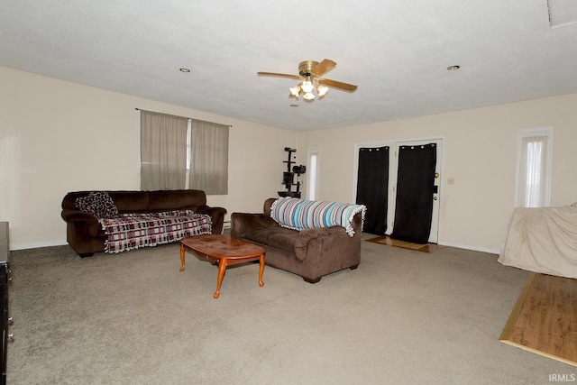 carpeted living room with ceiling fan