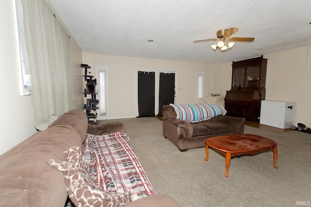 carpeted living room featuring ceiling fan