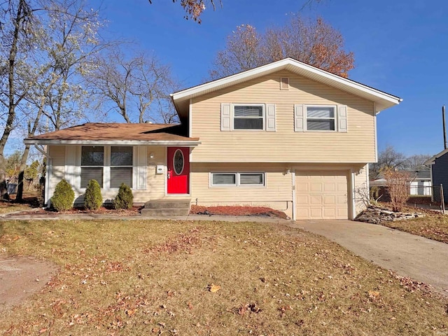 split level home with a garage and a front yard