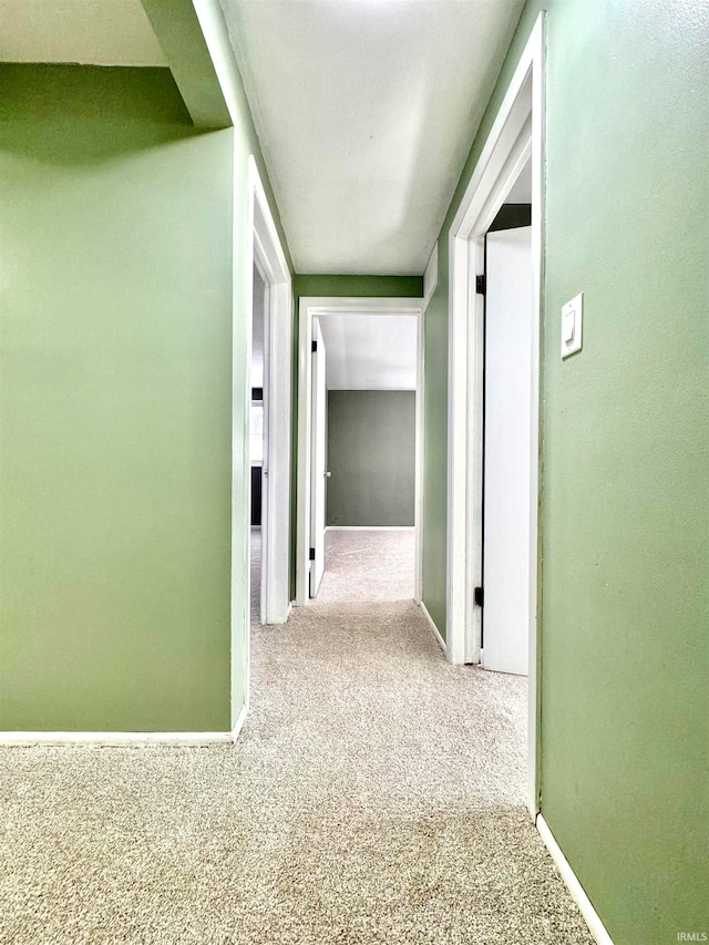 hallway with light colored carpet