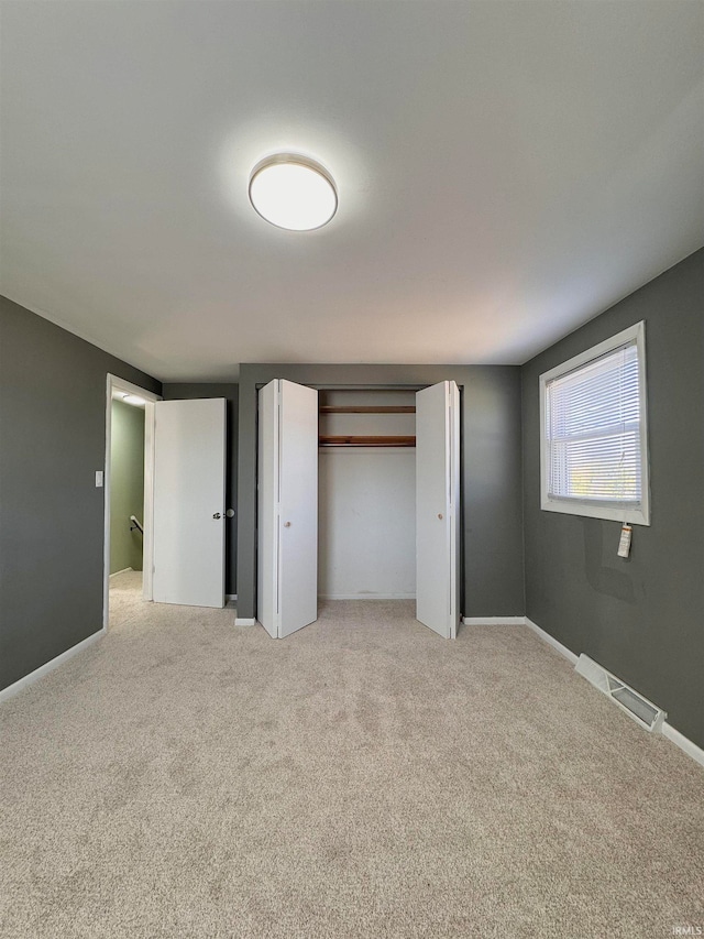 unfurnished bedroom with light colored carpet