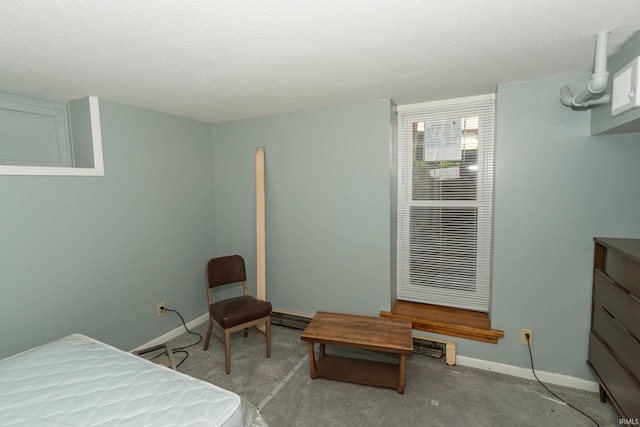 bedroom featuring a textured ceiling and light carpet