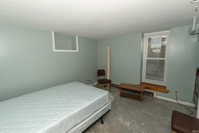 bedroom featuring concrete flooring and a textured ceiling