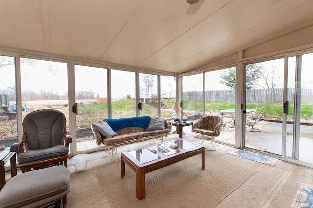 sunroom / solarium with lofted ceiling and a healthy amount of sunlight