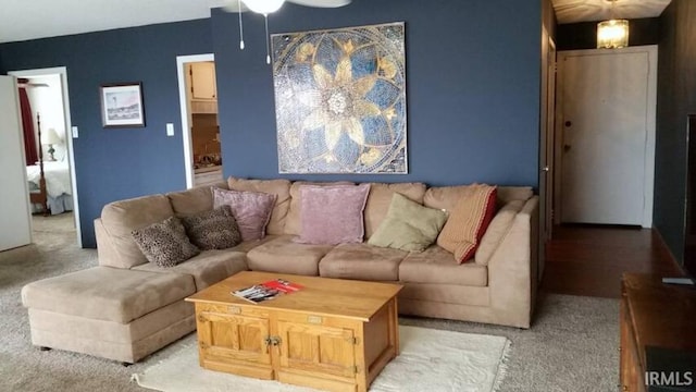 living room with light colored carpet and ceiling fan