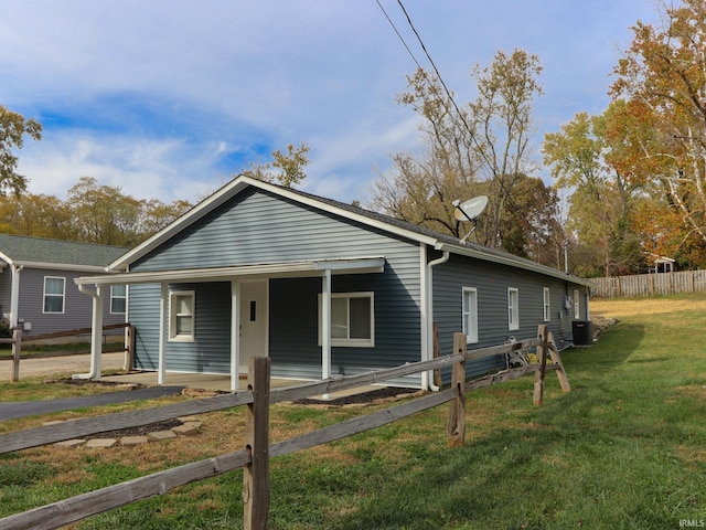 bungalow-style home featuring central air condition unit and a front yard