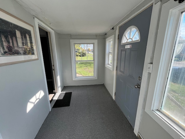 entryway featuring dark carpet