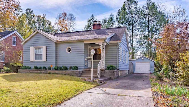 view of front of house featuring an outbuilding, a garage, and a front yard