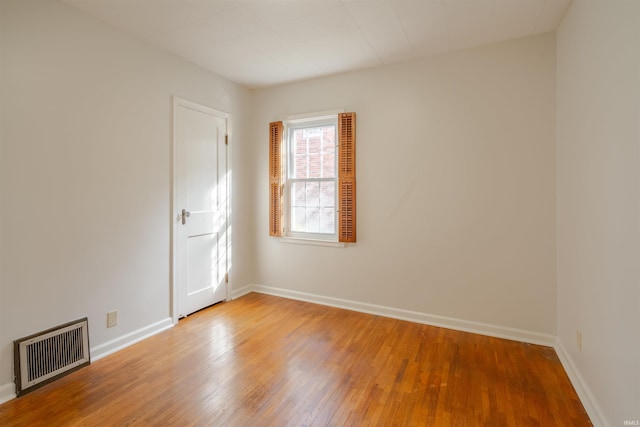 spare room featuring wood-type flooring