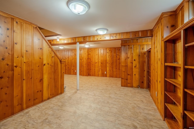 basement featuring wooden walls