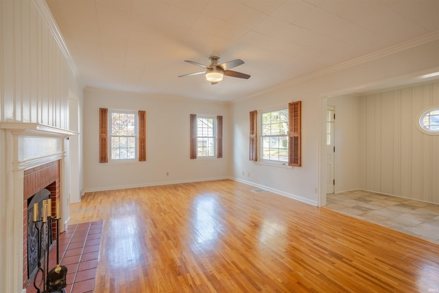 unfurnished living room featuring ceiling fan, crown molding, a brick fireplace, and light hardwood / wood-style flooring