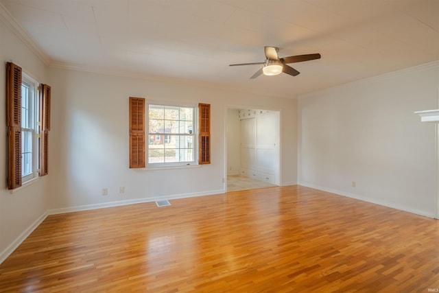 empty room with ceiling fan, light wood-type flooring, and crown molding