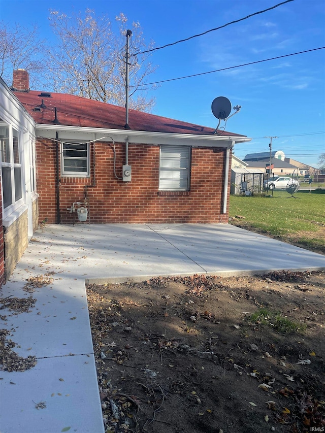 exterior space with a patio area and a lawn