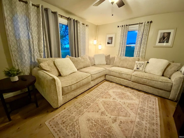 living room with wood-type flooring and ceiling fan