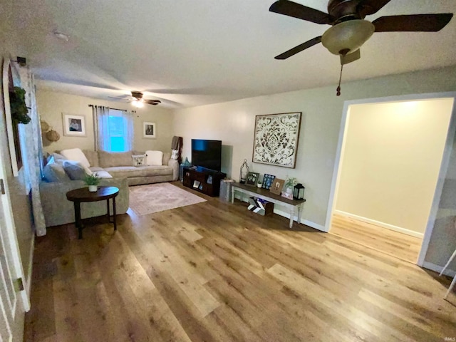 living room with hardwood / wood-style flooring and ceiling fan