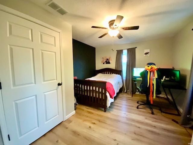 bedroom with light hardwood / wood-style flooring and ceiling fan