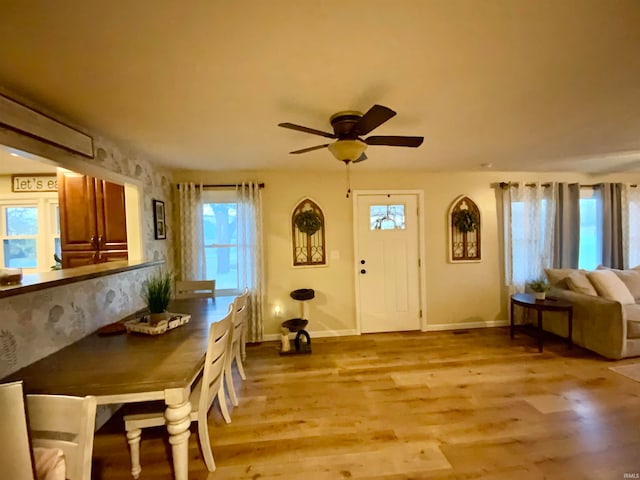 dining room with light wood-type flooring and ceiling fan