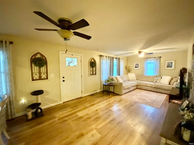 unfurnished living room with hardwood / wood-style flooring and ceiling fan